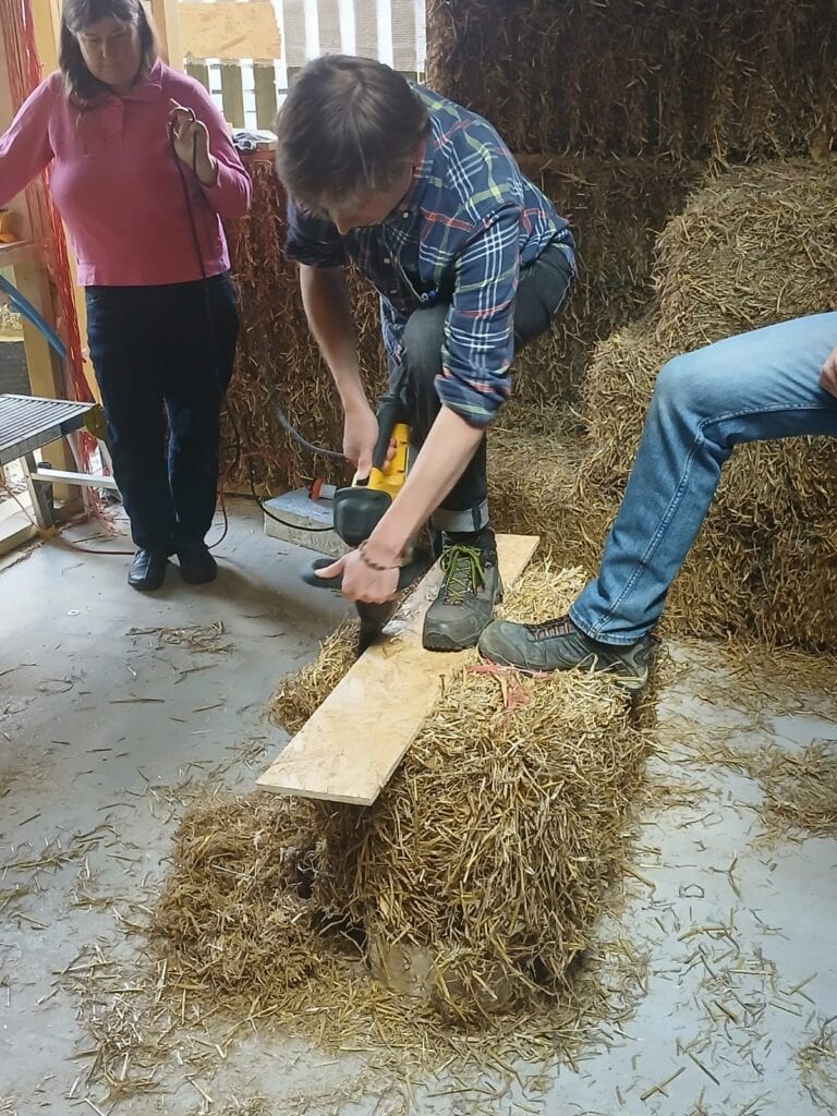 cutting a straw bale with an alligator saw